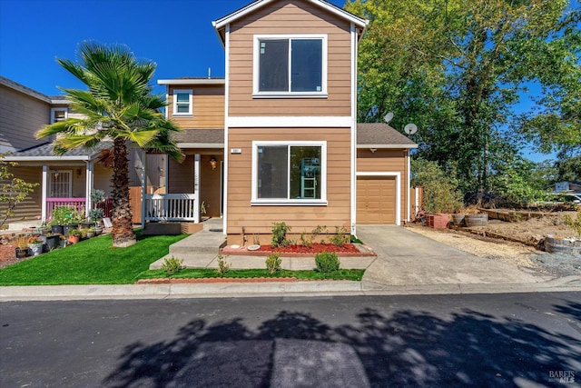 view of front of house with an attached garage, covered porch, and concrete driveway