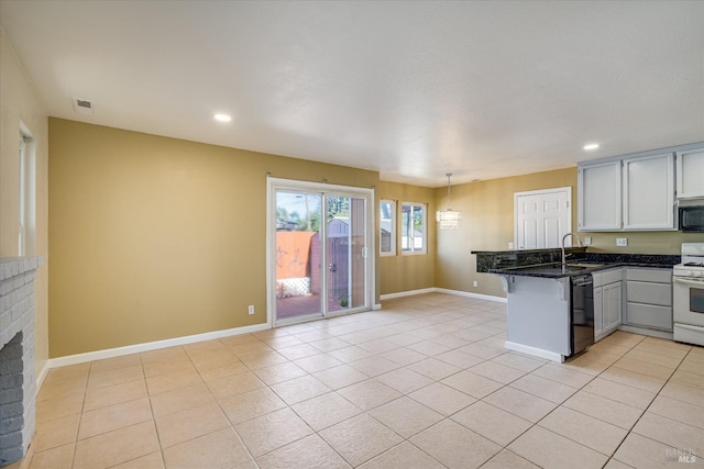 kitchen with white cabinets, dishwasher, a peninsula, pendant lighting, and a sink