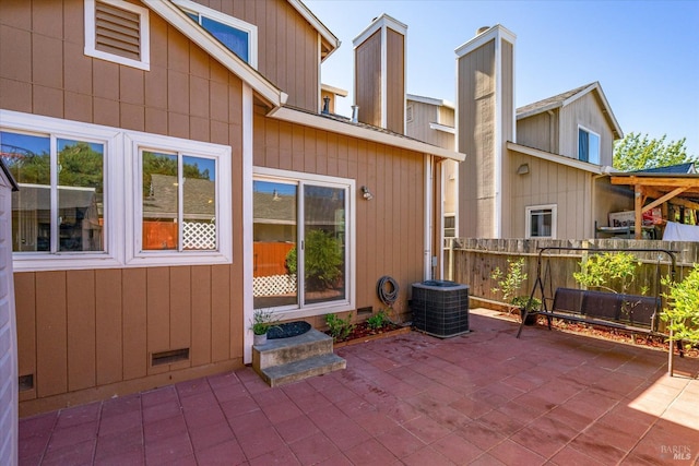 view of patio featuring central AC and fence