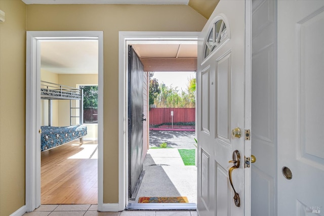 entryway featuring light tile patterned floors and a healthy amount of sunlight