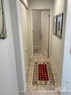 hall featuring baseboards