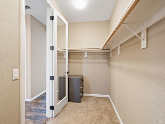 spacious closet featuring visible vents and carpet flooring