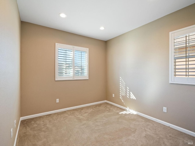 carpeted empty room with recessed lighting, a wealth of natural light, and baseboards