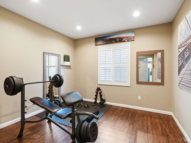 exercise room with baseboards, wood finished floors, and recessed lighting