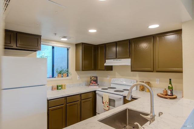 kitchen with light stone counters, recessed lighting, a sink, white appliances, and under cabinet range hood