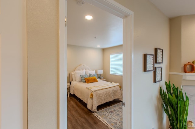 bedroom with dark wood finished floors and recessed lighting