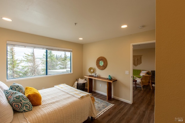 bedroom with recessed lighting, baseboards, and wood finished floors