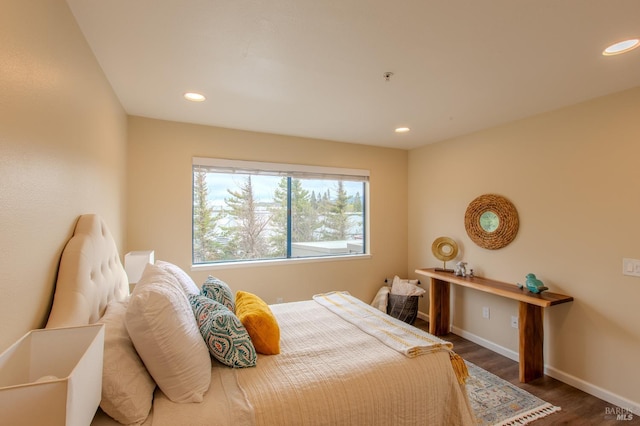 bedroom with recessed lighting, wood finished floors, and baseboards