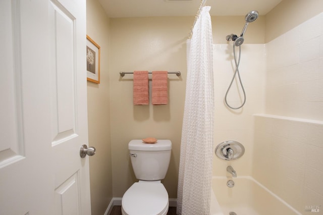 bathroom featuring toilet and shower / tub combo with curtain