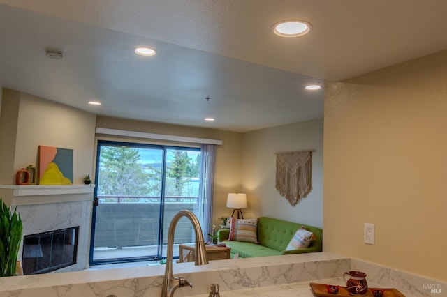 living area with recessed lighting and a premium fireplace