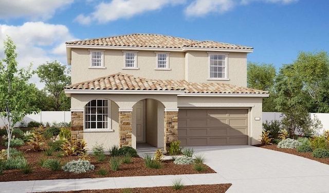 mediterranean / spanish house with a tiled roof, concrete driveway, fence, a garage, and stucco siding