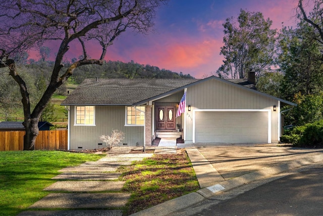 view of front of home featuring driveway, crawl space, an attached garage, fence, and a yard