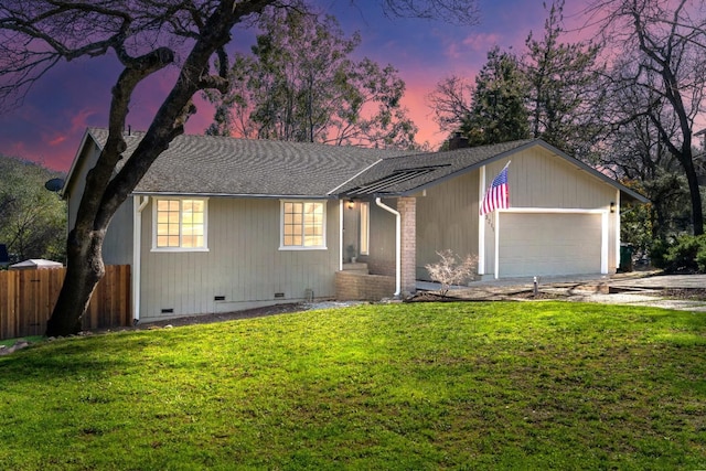 ranch-style house featuring a garage, fence, roof with shingles, crawl space, and a front yard