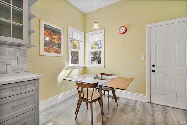 dining space featuring baseboards, breakfast area, and wood finished floors