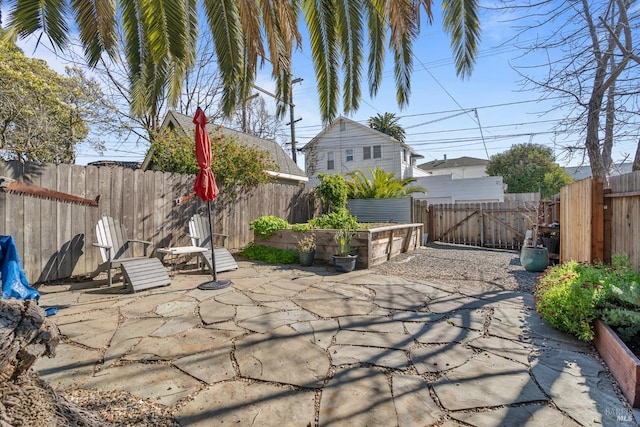 view of patio / terrace with a fenced backyard and a garden