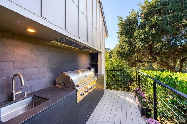 deck with a sink, area for grilling, and an outdoor kitchen