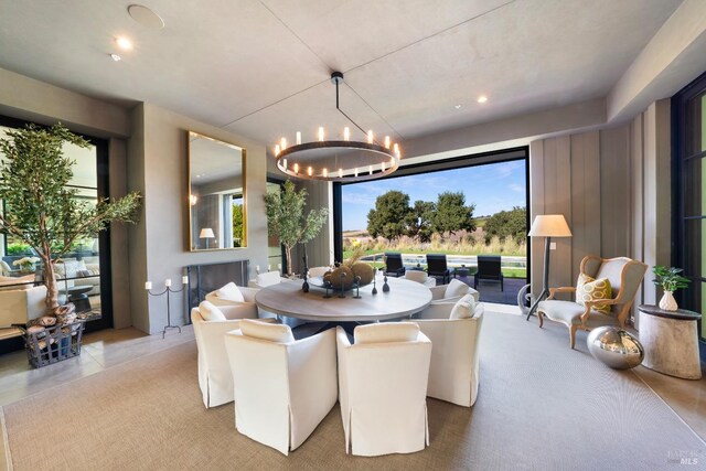 dining space with a healthy amount of sunlight and an inviting chandelier