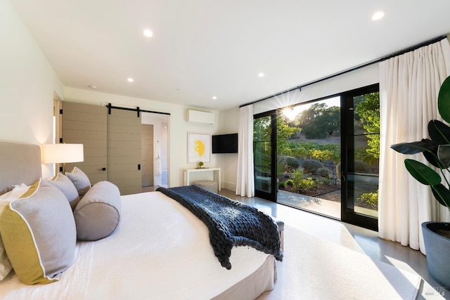bedroom featuring a wall unit AC, recessed lighting, finished concrete floors, and a barn door