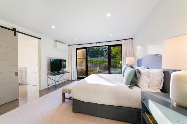 bedroom featuring an AC wall unit, recessed lighting, and a barn door