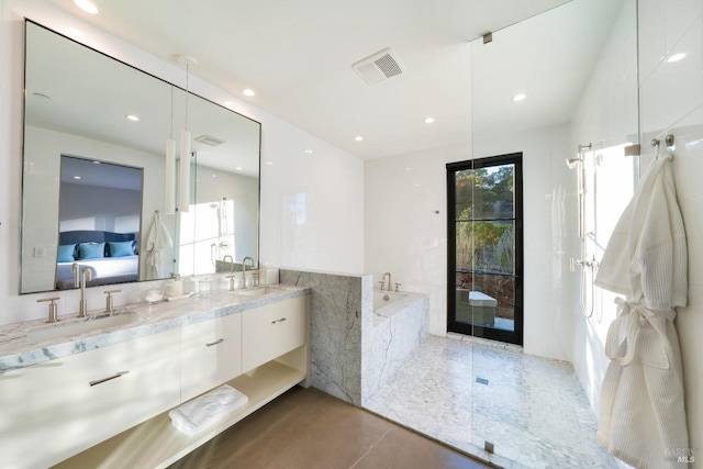 bathroom with a sink, visible vents, double vanity, and connected bathroom