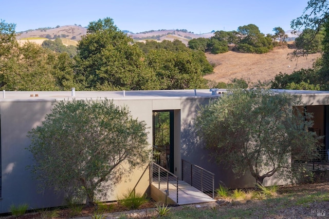 entrance to property with a mountain view and stucco siding