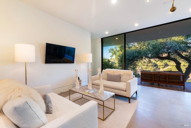 living room with a wall of windows and recessed lighting