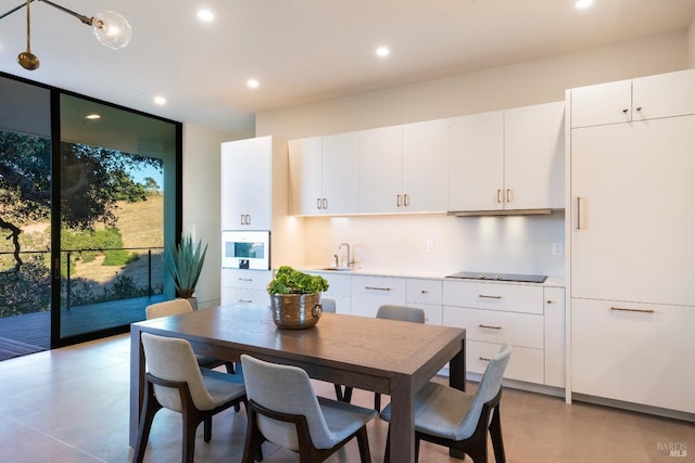 dining room featuring floor to ceiling windows and recessed lighting