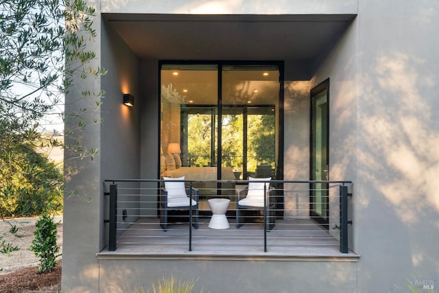 entrance to property featuring stucco siding