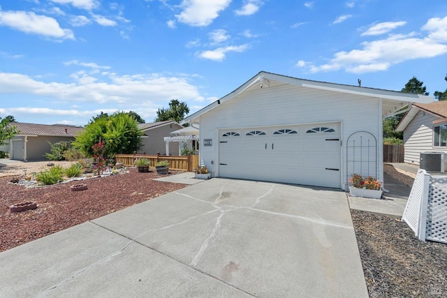 view of front of house with concrete driveway and central AC