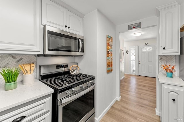 kitchen featuring white cabinetry and appliances with stainless steel finishes