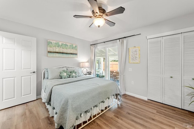 bedroom featuring access to exterior, light wood-style flooring, baseboards, and a closet