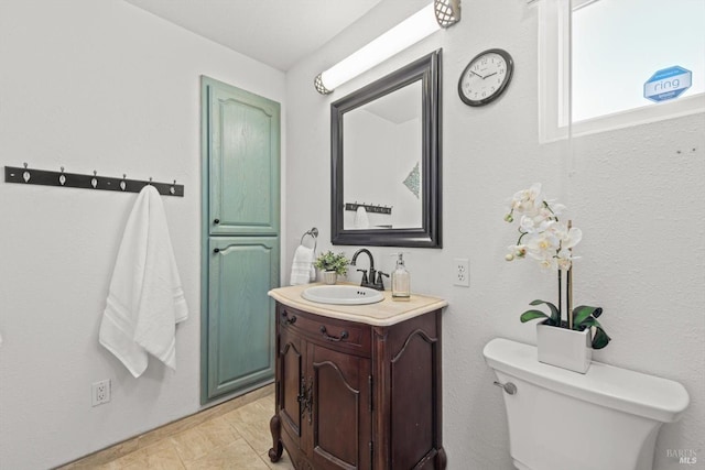 bathroom with toilet and vanity