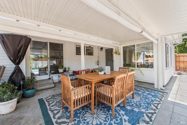 view of patio featuring fence and outdoor dining space