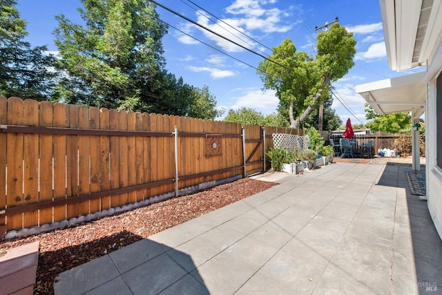 view of patio with fence and a gate