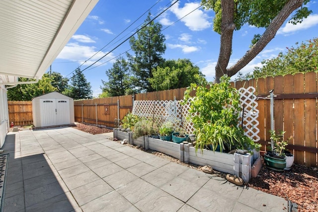 view of patio with a storage shed, a garden, a fenced backyard, and an outdoor structure