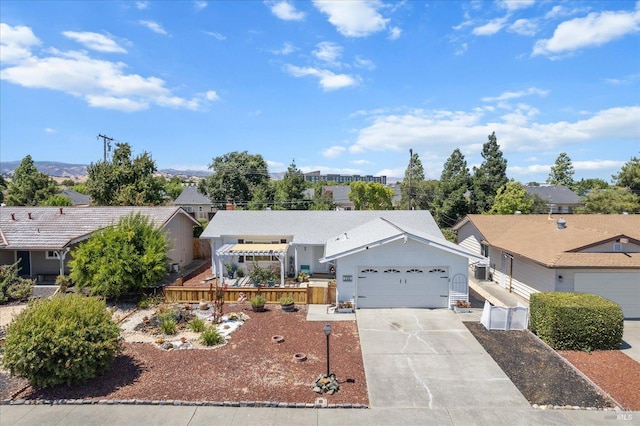 ranch-style house with an attached garage and concrete driveway