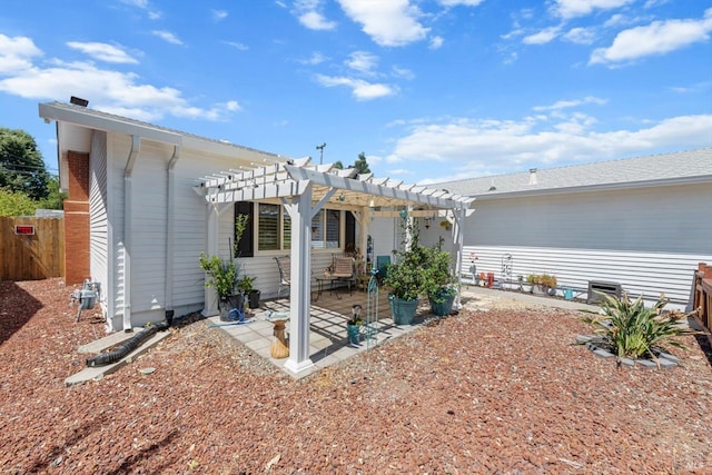 rear view of house featuring a patio area and a pergola