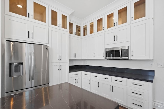 kitchen with stainless steel appliances, glass insert cabinets, and white cabinets