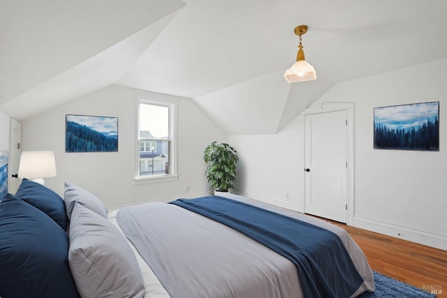 bedroom featuring vaulted ceiling and wood finished floors