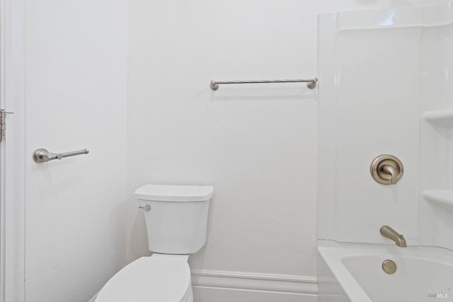 bathroom featuring toilet and baseboards