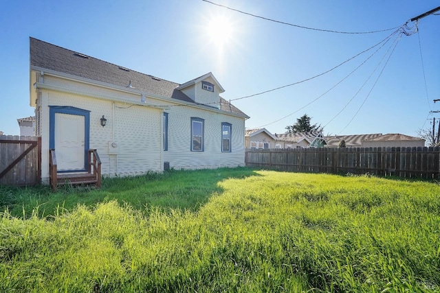 back of house featuring fence