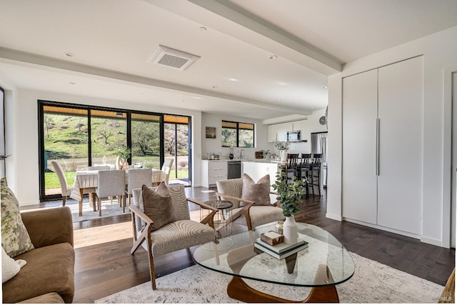 living area with recessed lighting, visible vents, and hardwood / wood-style flooring