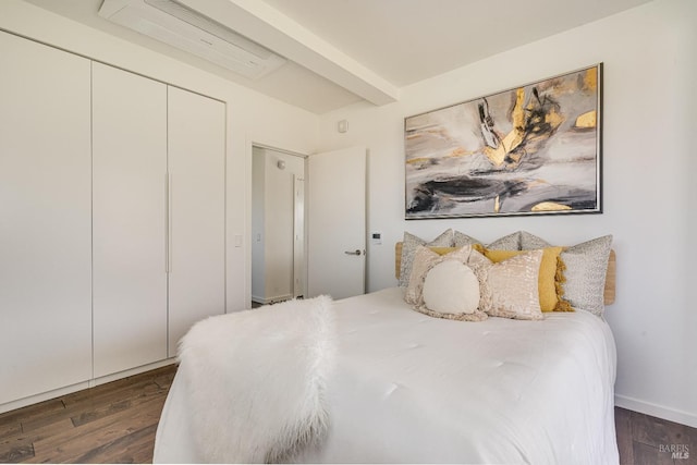 bedroom with a closet and dark wood-style flooring