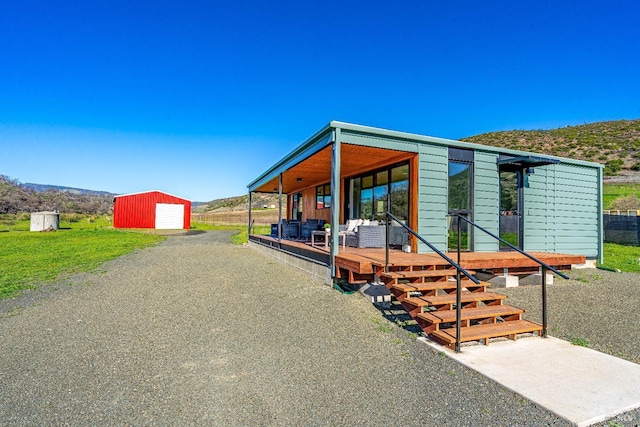 exterior space featuring an outbuilding and gravel driveway