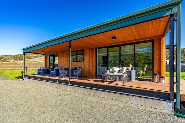 rear view of property with outdoor lounge area