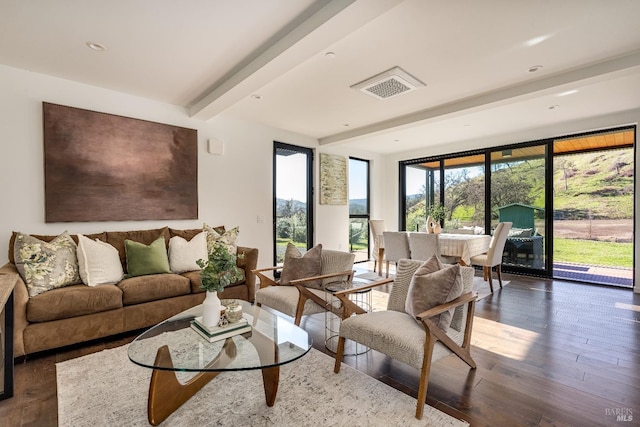 living area featuring visible vents, beamed ceiling, hardwood / wood-style flooring, and recessed lighting