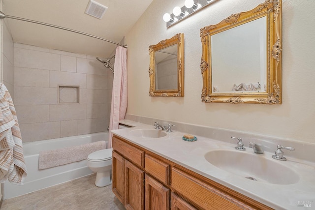 bathroom with shower / tub combo, visible vents, a sink, and toilet