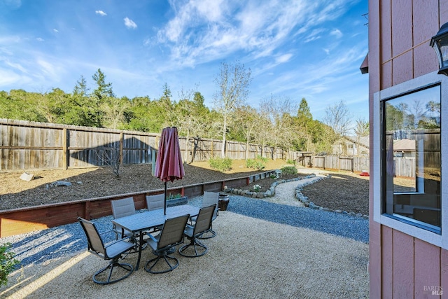 view of patio with outdoor dining space and a fenced backyard