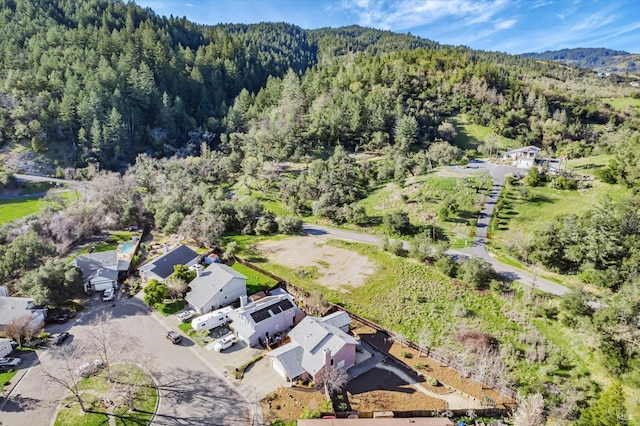 drone / aerial view featuring a forest view