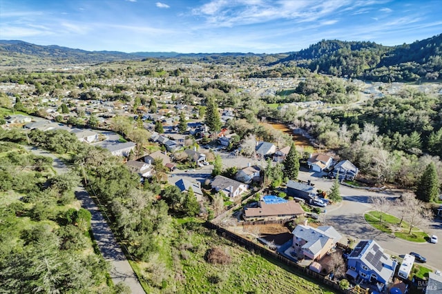 drone / aerial view featuring a residential view and a mountain view